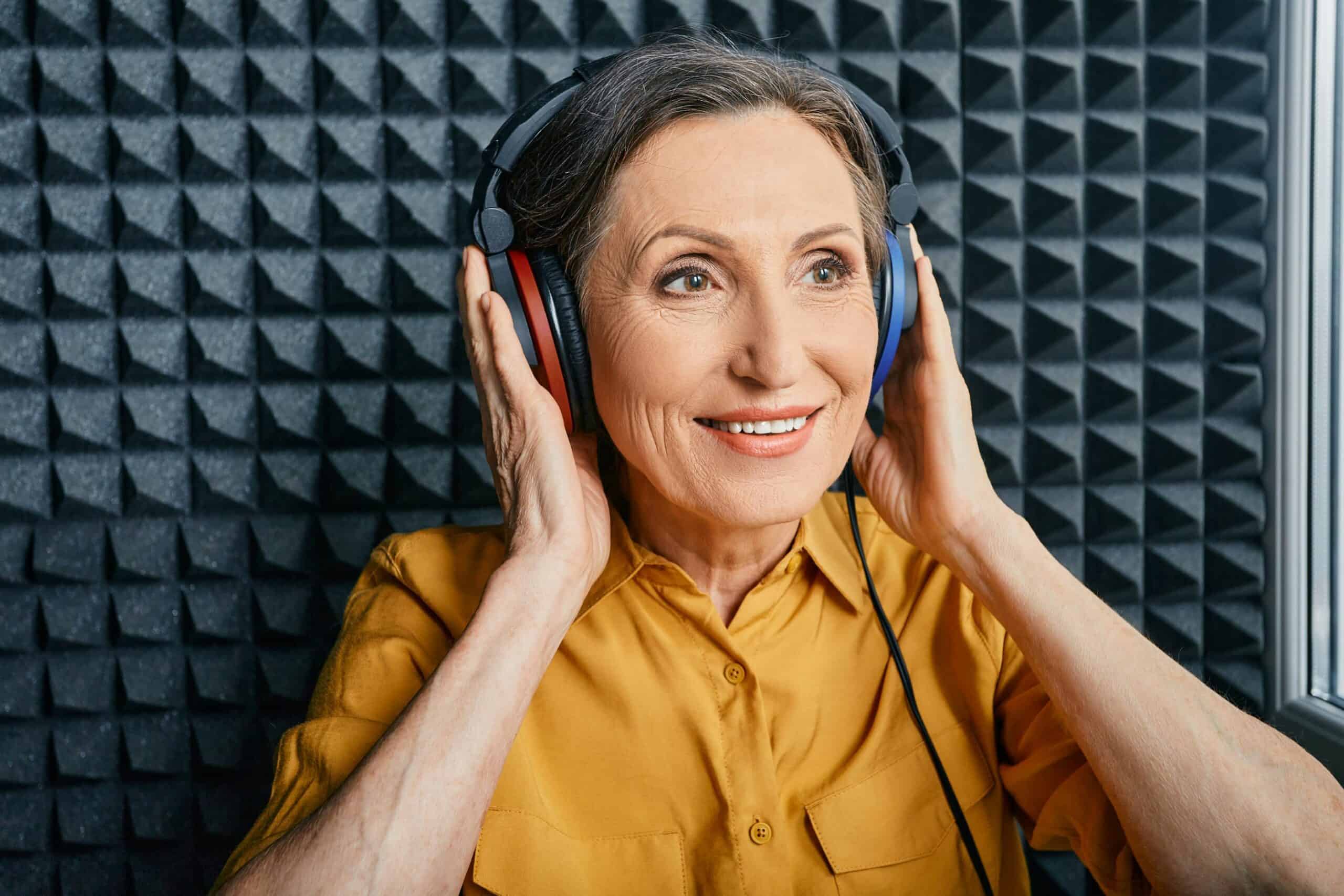 Woman in hearing booth getting hearing test